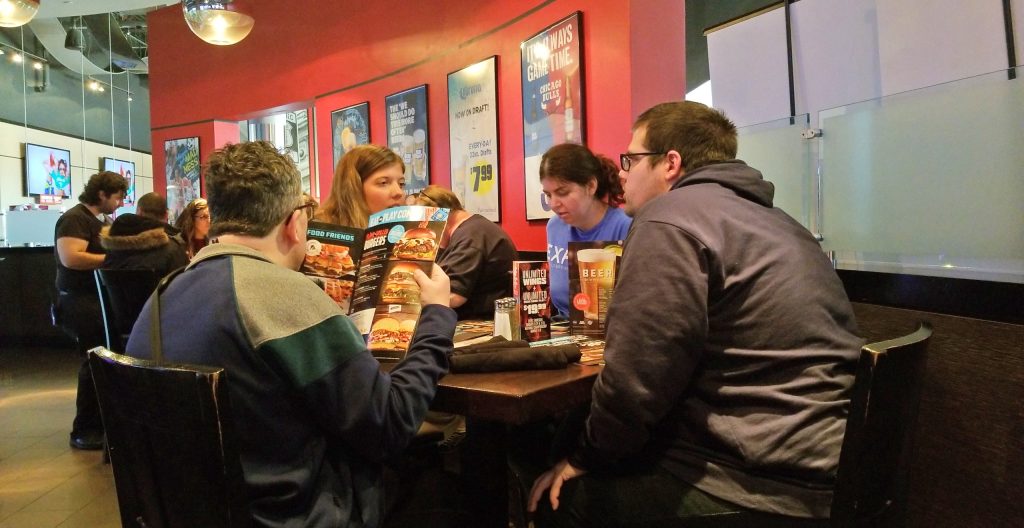 A group of people eating at a restaurant.