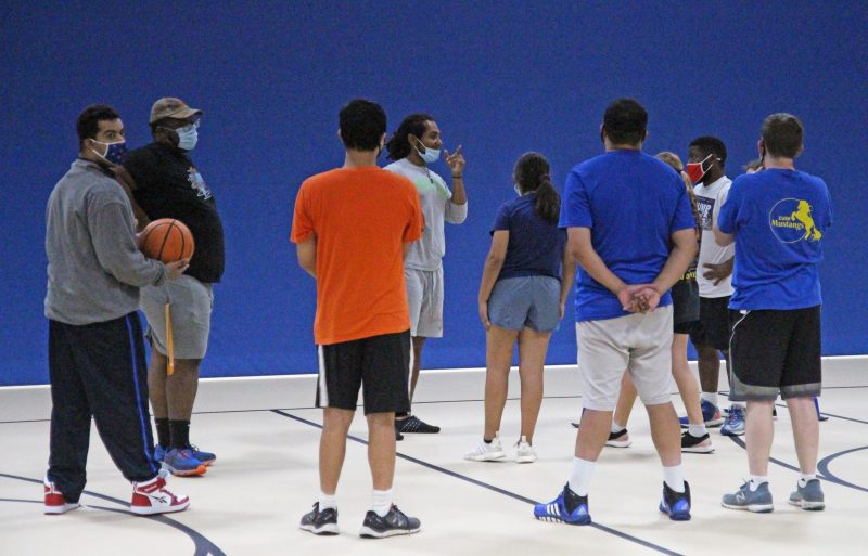 A group of people on a basketball court.