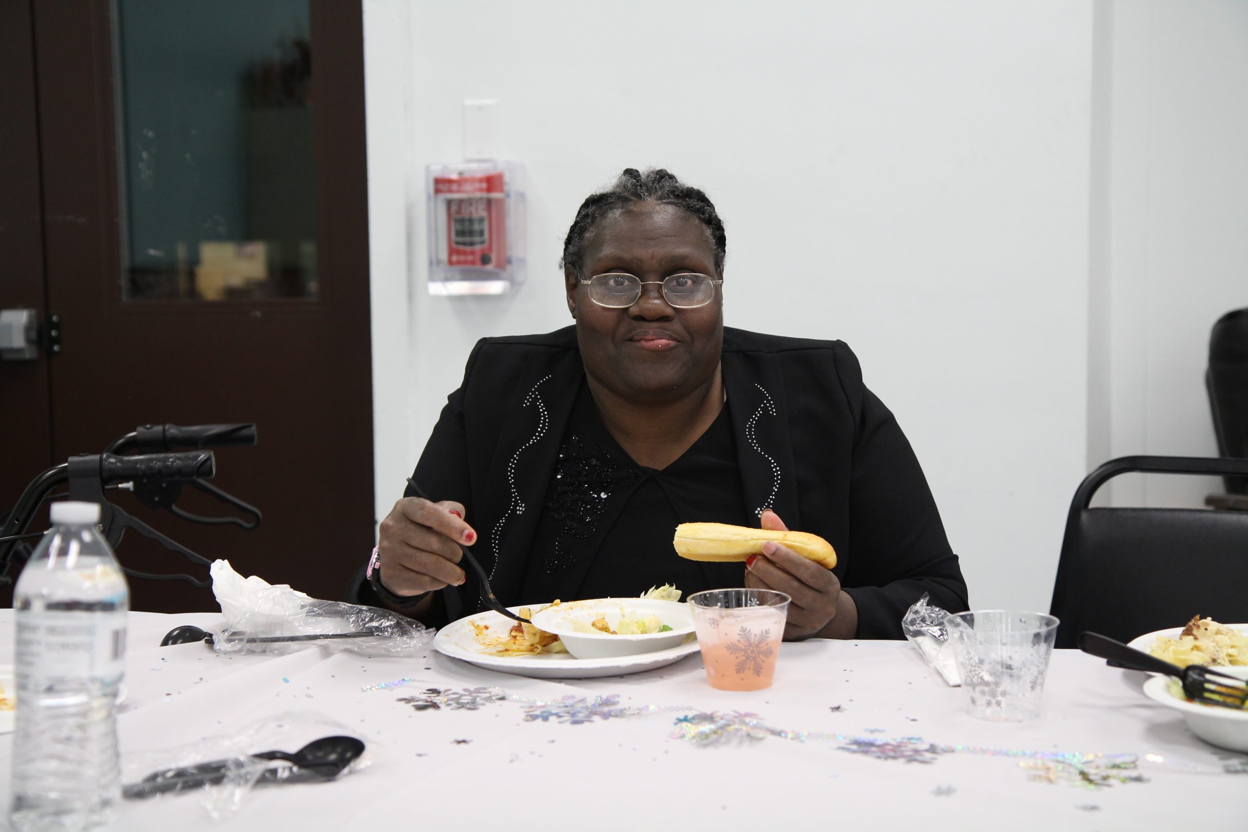 A person dressed up eating a meal.
