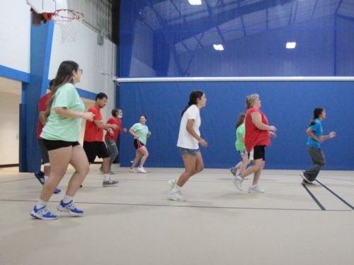 People doing activities in a gymnasium.