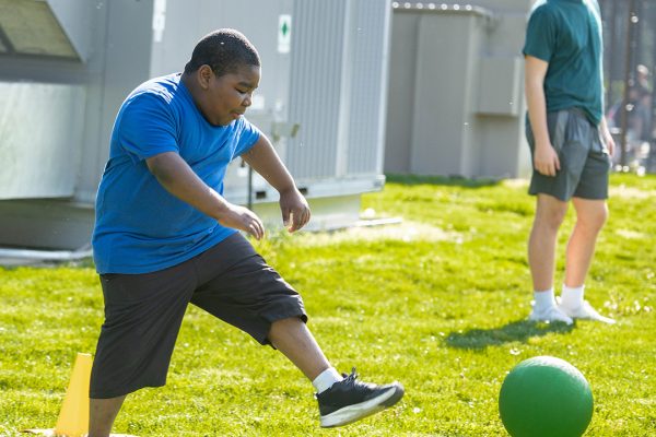 CUSR participant kicking a kickball
