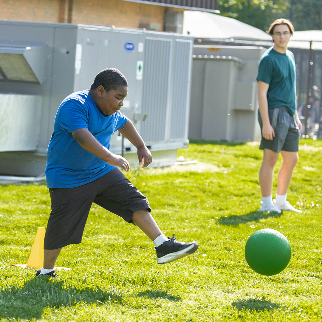 CUSR participant kicking a kickball