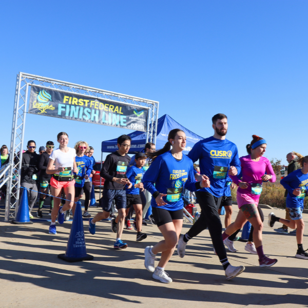 A group of racers crosses the start line.